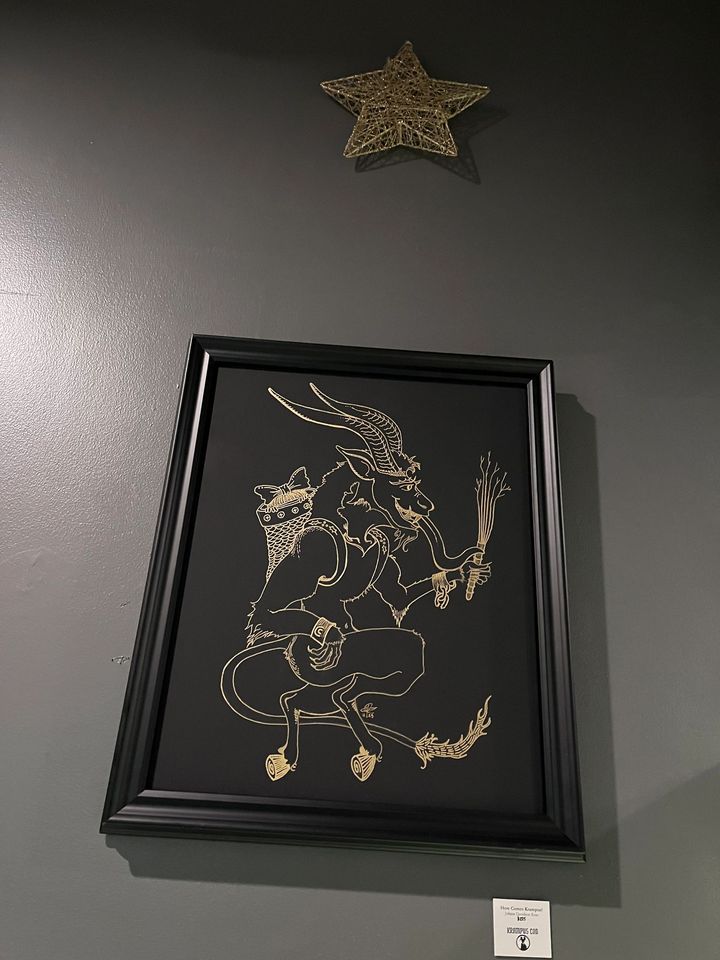 Framed Krampus artwork on display