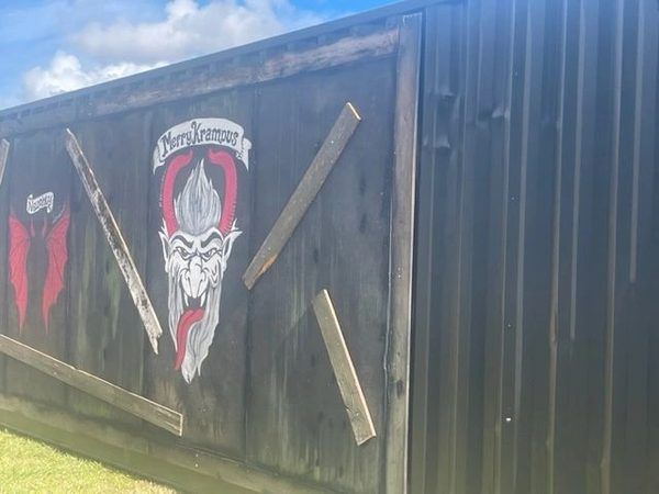 Hand-painted Krampus artwork on a wooden panel at Krush Brau Park
