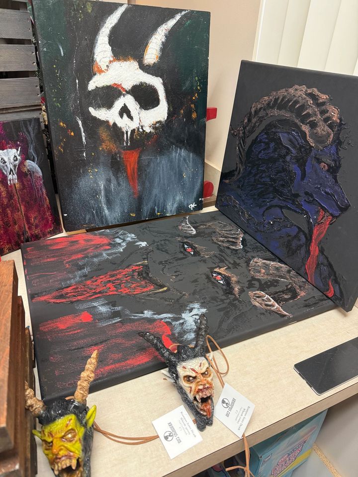 Krampus paintings in progress in an artist studio